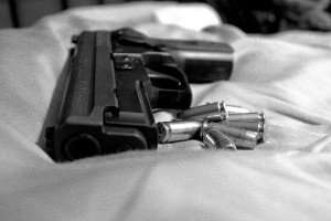 Gun lying on bed