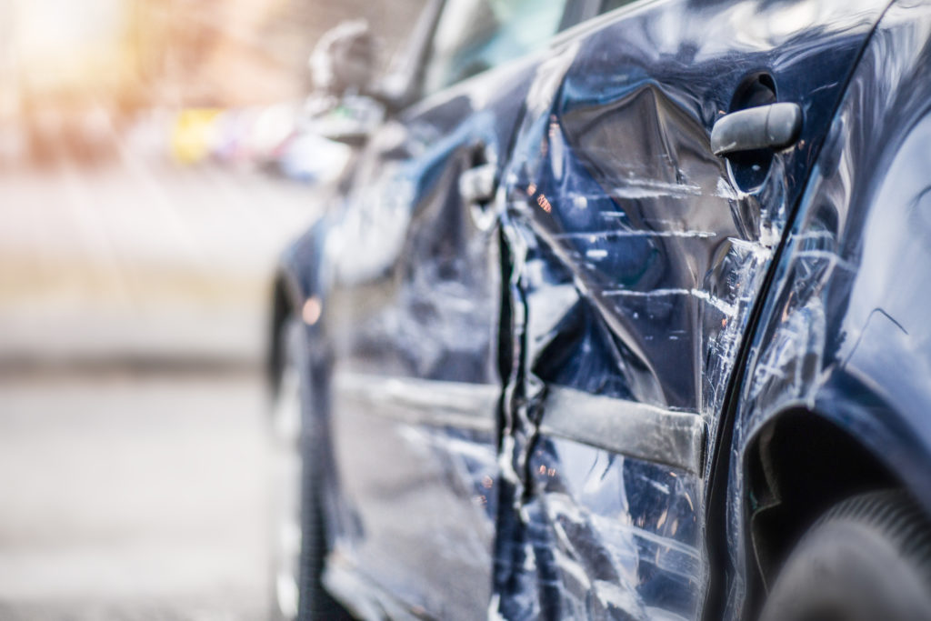 Damaged blue car covered by good car insurance in Florida