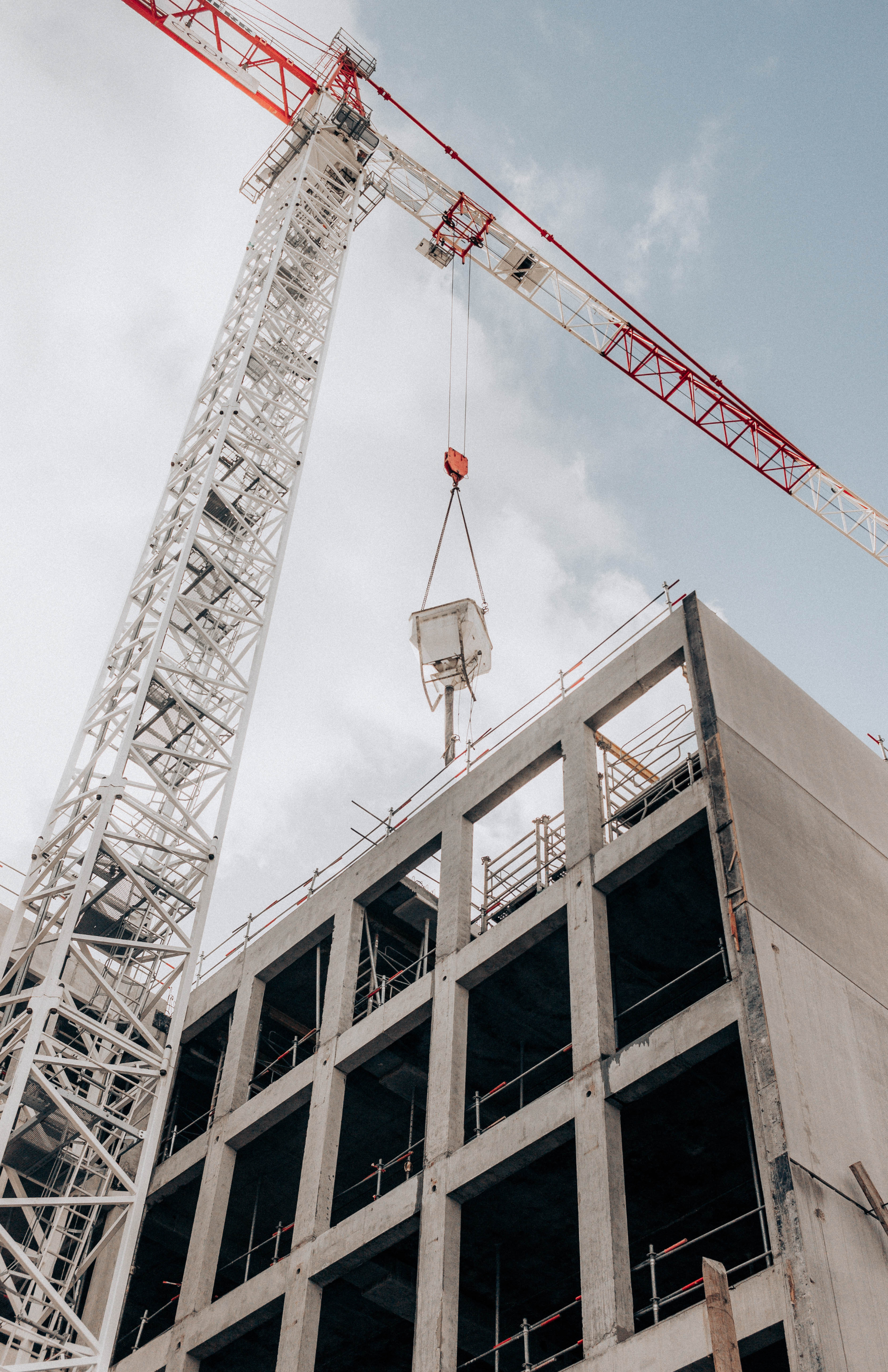 A crane lifting heavy materials during construction of a high-rise.