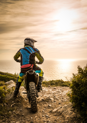 A rider prepares to hit the road at dawn, reassured by the availability of our motorcycle accident lawyers for support.
