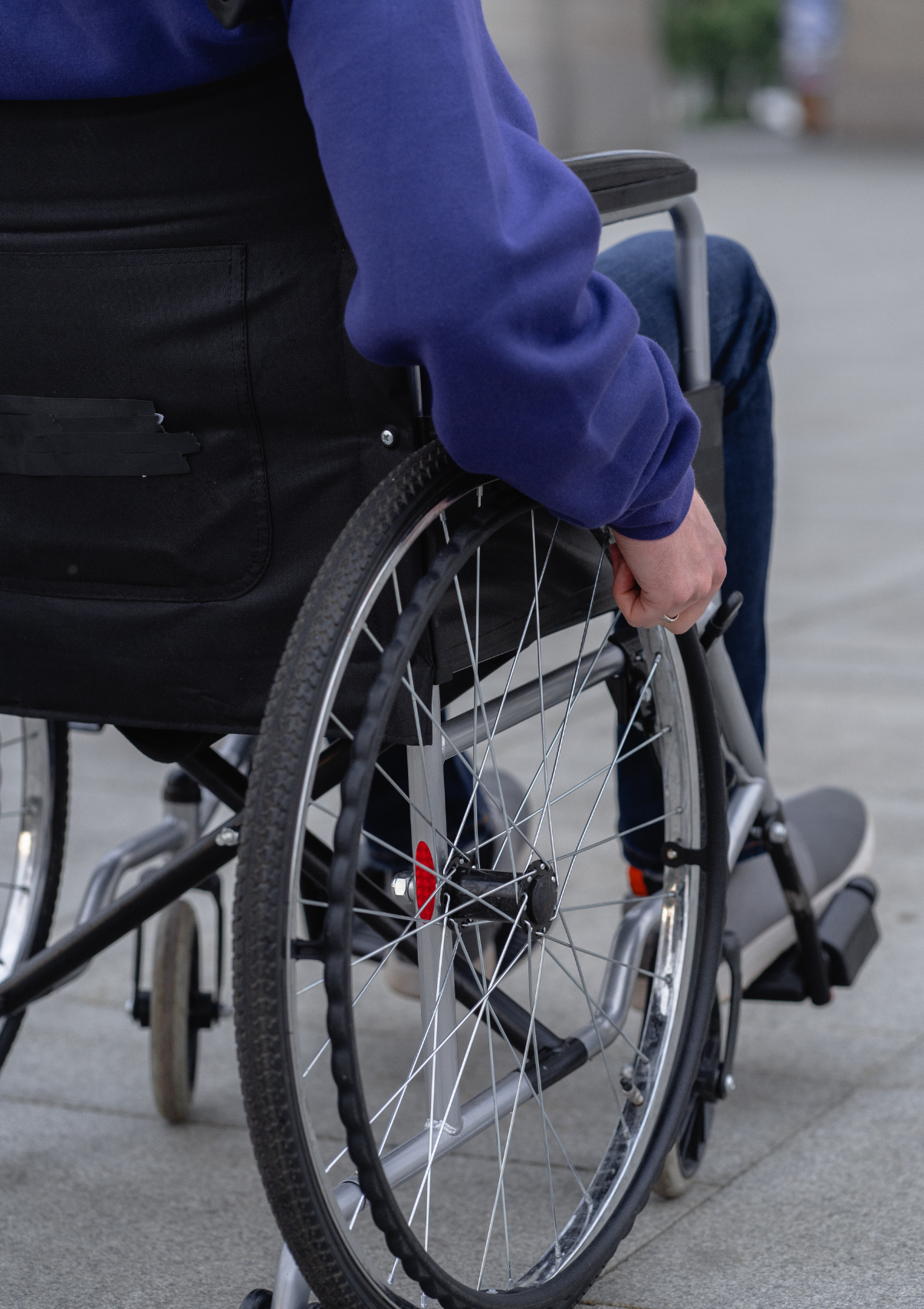 A man pushes his wheelchair to a disability claims dispute lawyer for legal help.