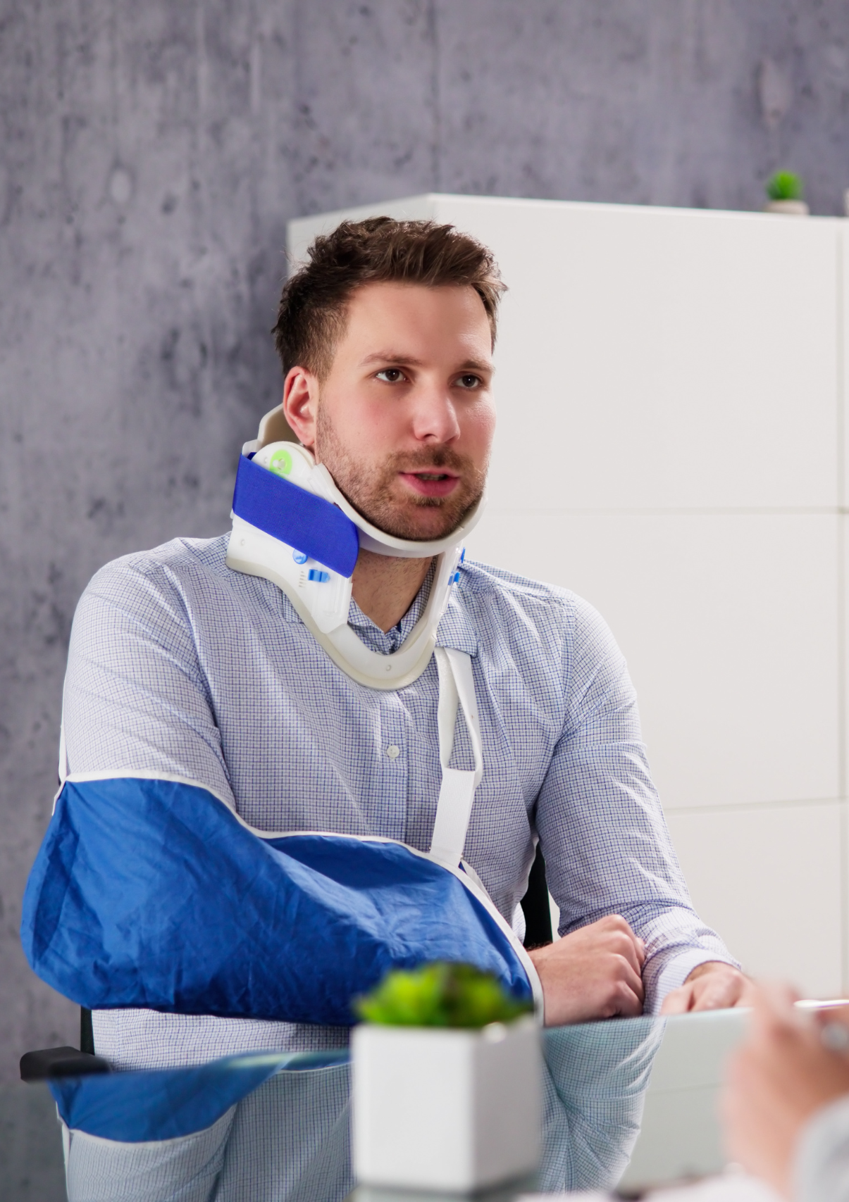 Man with neck brace and arm cast during a free consultation with a Florida personal injury lawyer.