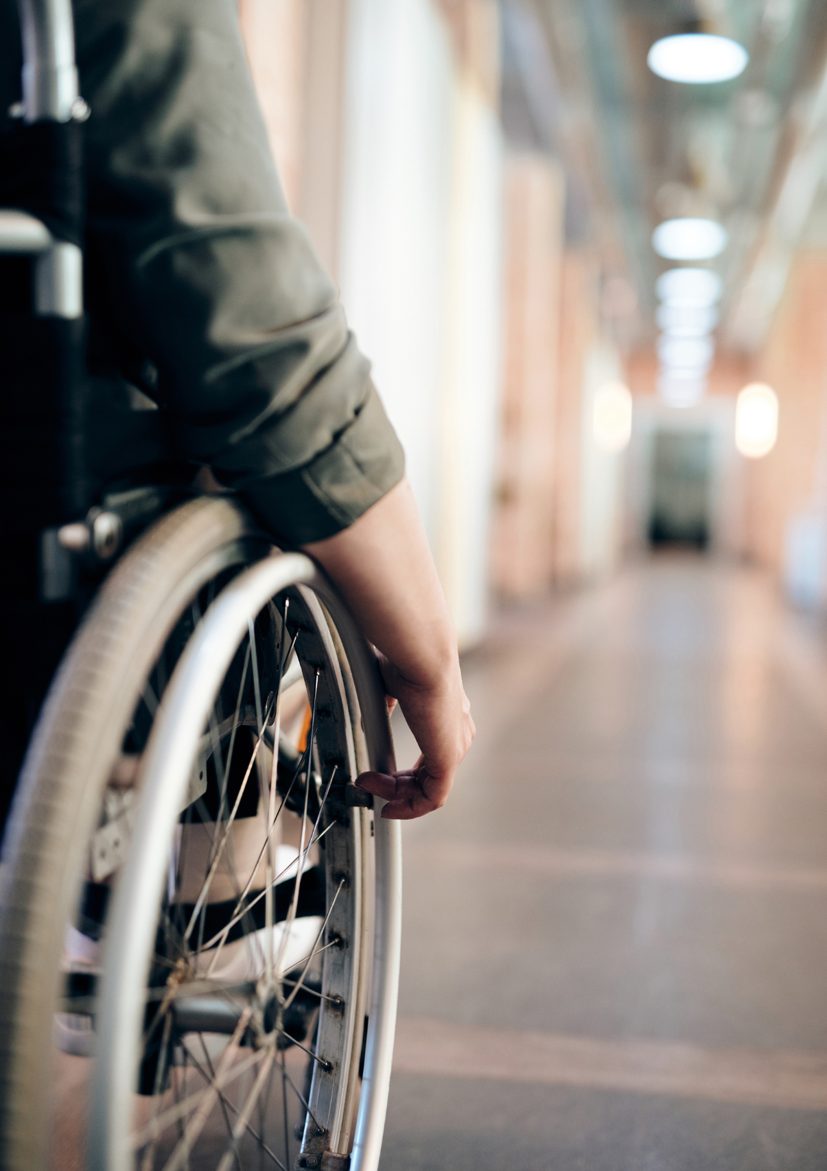 A man pushes his wheelchair toward a Florida disability lawyer's office.